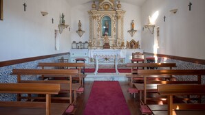 A church interior with pews, a central altar, and religious statues. - Holiday Home on Estate With Vineyards, Olive Groves and Swimming Pool (Vila Flor)