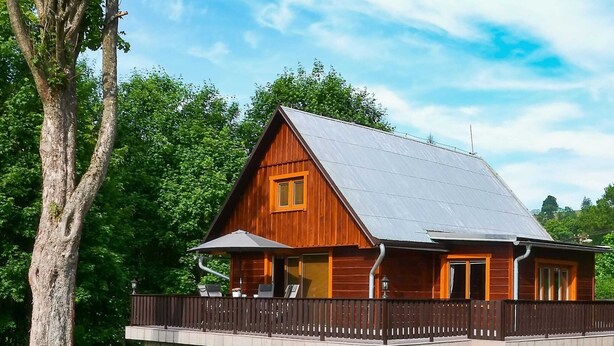 A wooden cabin with a porch, surrounded by trees and a picnic table. - Relaxing Forest Escape With BBQ (Krasna Lipa)