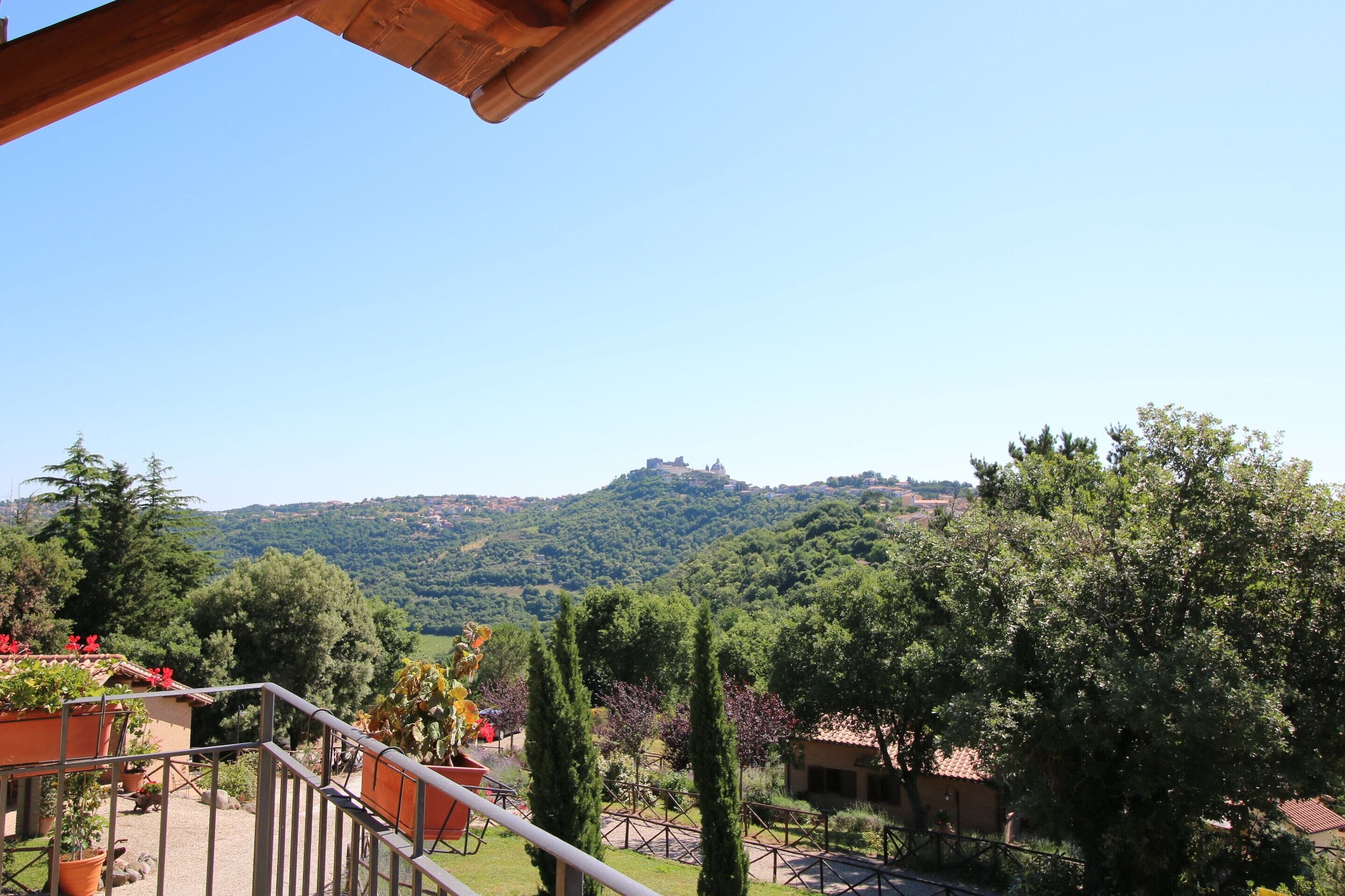 A balcony with a view of a hill and a castle.