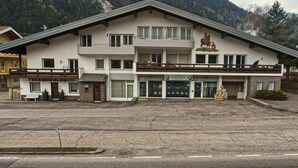 A two-story building with a balcony and a sign that reads "Cambielli Edilfruti". - Apartment in Predazzo Near Dolomiti Superski (Predazzo)