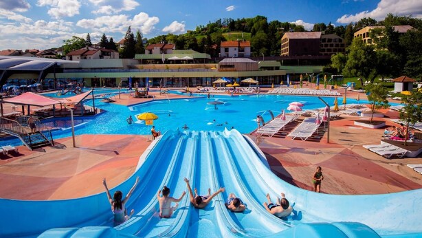 A water park with multiple slides and pools, surrounded by buildings and trees. - Lovely Holiday House With Big, Private Garden, Near Well Known SPA Centre (Tuhelj)