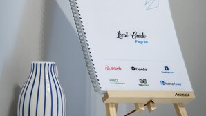 A spiral-bound local guide for Pagratiti with logos of travel and accommodation services. - Beautiful studio at Panathenaic Stadium (Athens)