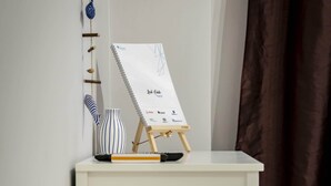 A desk with a sketchpad, a small easel, and a striped vase. - Beautiful studio at Panathenaic Stadium (Athens)
