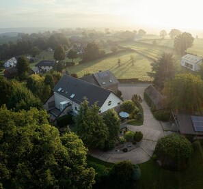 A residential area with houses, trees, and a clear sky. - Group Getaway in Amel (Amel)