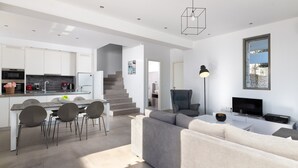 A modern, open-plan living area with a kitchen, dining space, and seating area. - Sea View Villa in Kalythies with Private Pool near 3 Beaches (Rhodes)
