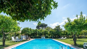 A rectangular swimming pool with a metal ladder on one side, surrounded by a brick patio. - Holiday Home in Guardavalle Near Beaches (Stilo)