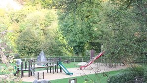A playground with slides and climbing structures surrounded by trees. - Home in Comblain-au-pont (Comblain-au-Pont)