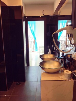 Regadera, secadora de cabello, toallas, papel de baño 