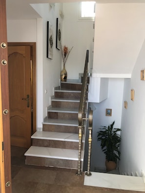 A staircase with a handrail, a wooden door, and a potted plant. - Villa Casa Rosi, sea view, private swimming pool, A/C and WIFI (Nerja)