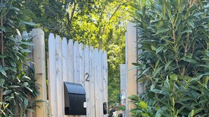 A wooden gate with a mailbox and a number '2' sign. - Modern 1 bed/Studio - Steps from the Center of Town (Provincetown)