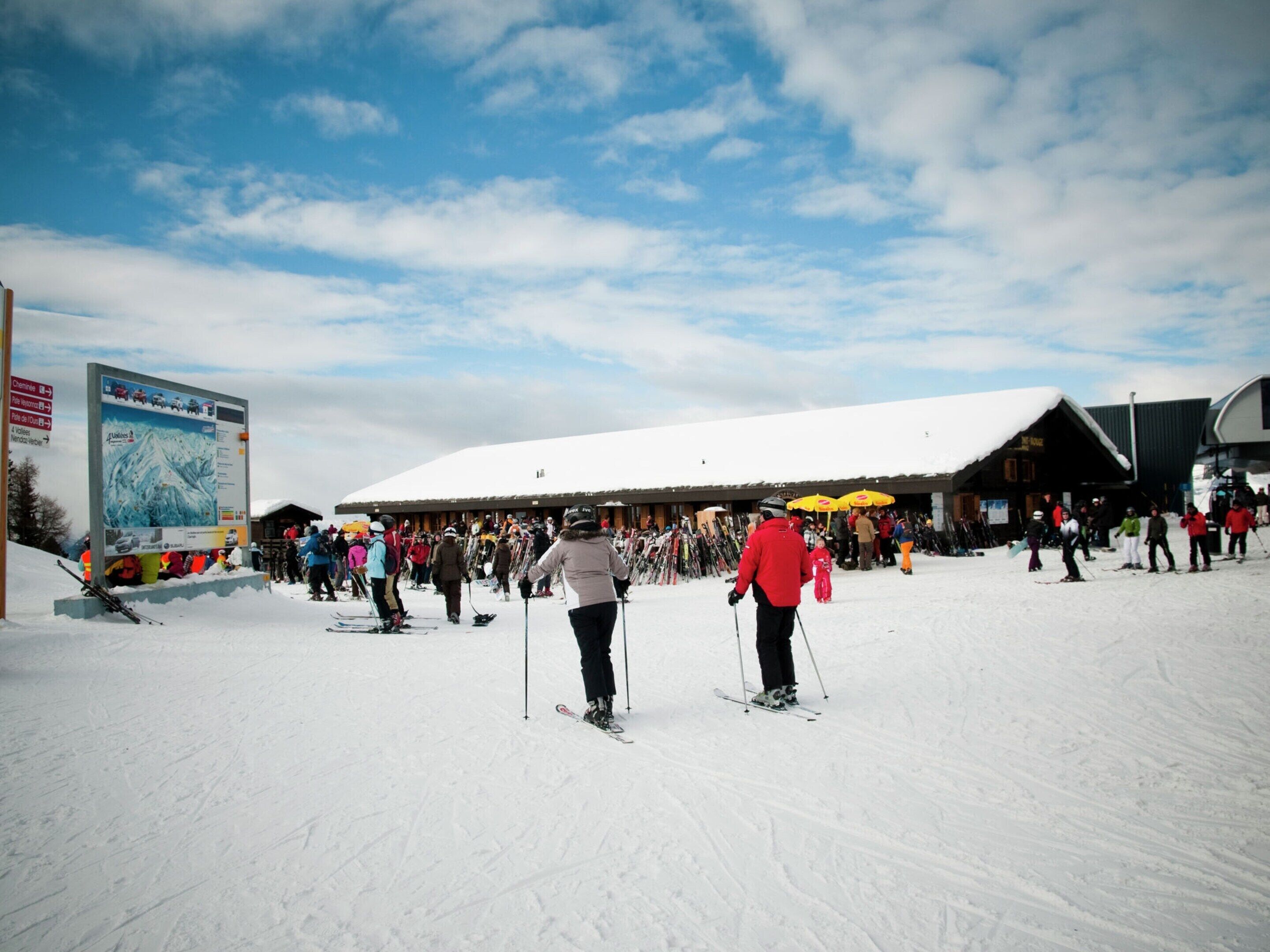 A ski resort with a large building and a ski lift.