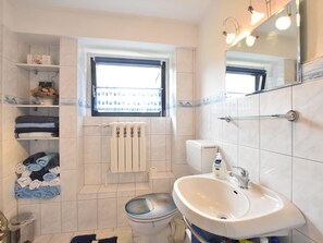 A bathroom with a toilet, sink, and towel rack. - Apartment in Proseken With Terrace (Gaegelow)