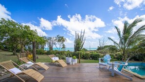 A wooden deck with lounge chairs and a pool. - LAGON BLANC (LE VAUCLIN)