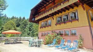 Ein zweistöckiges Gebäude mit Balkonen, Außenbereich und blauem Himmel.