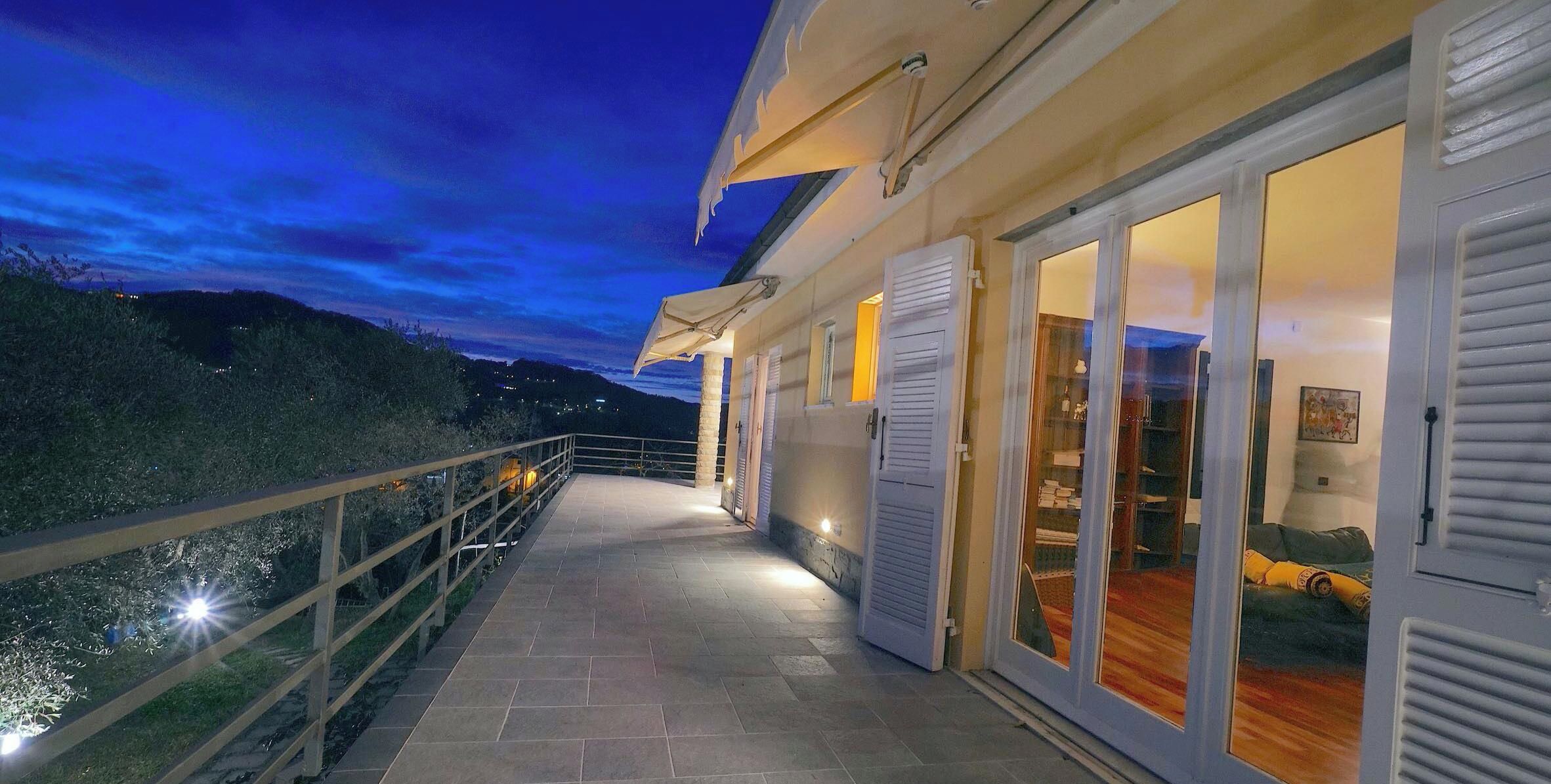 Eine zweistöckige Villa mit einem Balkon mit Blick auf eine reizvolle Landschaft.