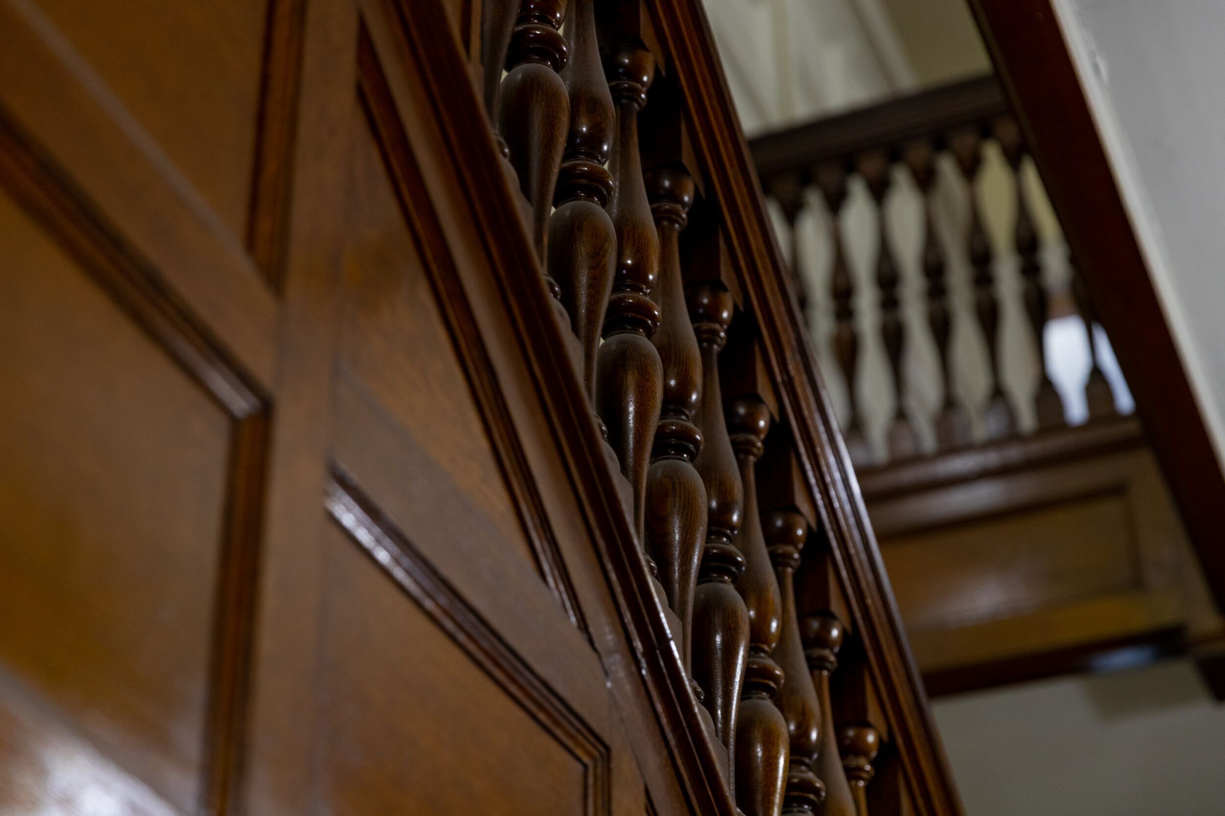 A close-up of a wooden staircase with ornate balusters.