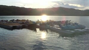 A boat docked at a marina with a sunset in the background. - Peaceful Stay With Garden (Alto Reno Terme)