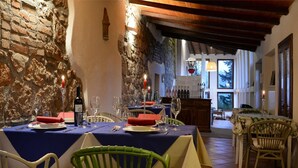 A dining area with stone walls, wooden beams, and tables set for a meal. - Tuscan Hideaway With Pool (San Casciano dei Bagni)