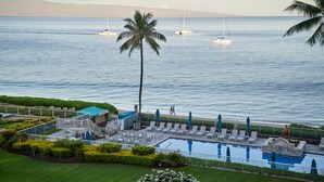 A resort pool area with lounge chairs and a view of the ocean. - AEI at The Whaler Kaanapali Beach Resort (Lahaina)