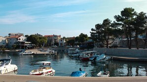A marina with several boats docked, surrounded by buildings and trees. - Apartment in Croatia With Balcony (Malinska-Dubasnica)