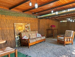 A rustic wooden interior with a sofa and chairs, a small table, and a decorative wall. - Countryside Home in Arezzo With Pool (Arezzo)