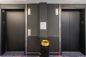 An elevator with a sign indicating it is a fire elevator. - San Francisco | City Stay | Fitness Center & Game Room | 3BR Sleeps 6 (San Francisco)