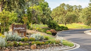 A landscaped entrance with a sign reading "Wynham by Wyndham." - Angels Camp | Friends & Family Golf Getaway | Pool + Golf | 3BR Sleeps 8 (Angels Camp)