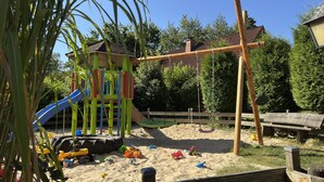 A playground with a slide, climbing structures, and sand. - Holiday Home in the Teutoburg Forest (Brakel)