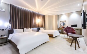 A hotel room with two beds, a desk with a chair, a TV, and a large window with curtains. - Idun Hotel (Wanju)