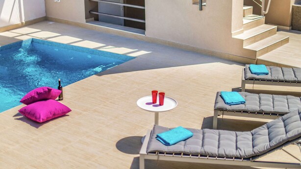 A rooftop pool area with lounge chairs and a small table. - Modern Villa in Salakovci With Private Pool (Labin)