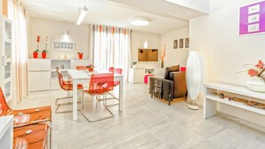 A modern living room with a dining area, a sofa set, a white fan, and a TV. - Modern Villa in Salakovci With Private Pool (Labin)