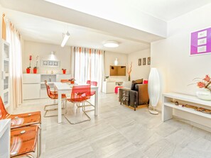 Relax in this stylish living space with a dining area, seating area, and kitchenette.