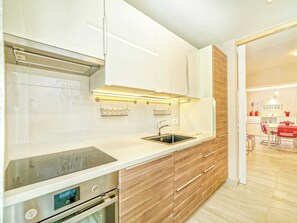 Enjoy cooking in this well-equipped kitchen with an oven and stainless steel sink.