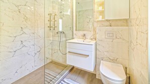 A modern bathroom with a glass-enclosed shower, a white sink, and a toilet. - Modern Villa in Salakovci With Private Pool (Labin)