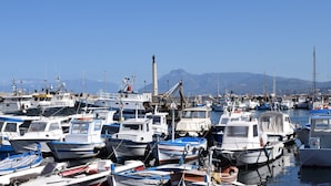 A marina with various boats docked, a prominent monument in the background, and mountains in the distance. - Splendid Holiday Home in Castellammare del Golfo near Beach (Castellammare del Golfo)