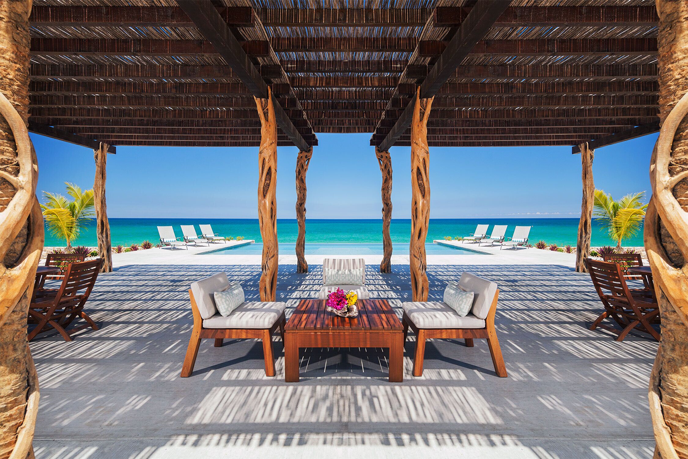 Shaded seating overlooking infinity pool.