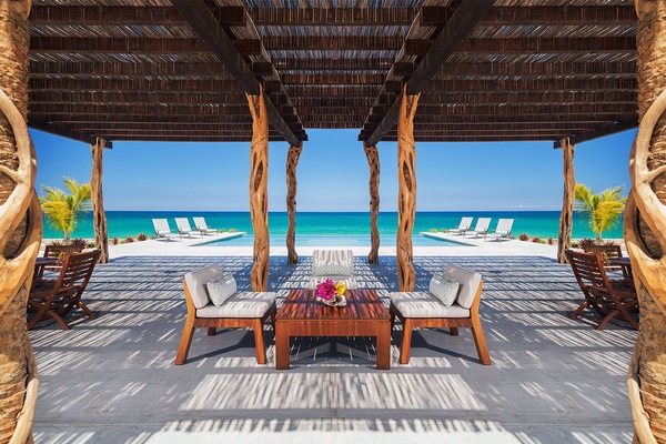 Shaded seating overlooking infinity pool.