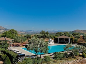A pool area with a view of distant hills, surrounded by trees and a gazebo. - Holiday Home With Pool, Sicily (Castellammare del Golfo)