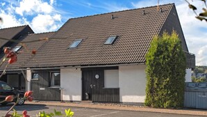 A single-story building with a sloped roof, a small window, and a door. - Large Apartment near Ski Area in Winterberg Germany (Winterberg)