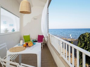 Enjoy a romantic meal for two on this balcony overlooking the sea.