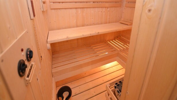 A sauna with wooden walls and benches. - Holiday Home With Private Pool in Bohemian (Vrchlabi)