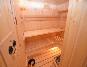 A sauna with wooden walls and benches. - Holiday Home With Private Pool in Bohemian (Vrchlabi)