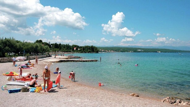 A beach with people sunbathing, swimming, and playing. - Apartment in Sveti Vid Near the Adriatic (Malinska-Dubasnica)