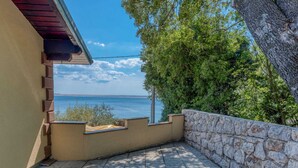 A balcony with a stone wall and a view of the sea. - Exotic Holiday Home in Tribanj-Krušćica near Sea (Starigrad)