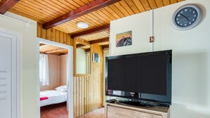 A room with a bed, a television, and a clock on the wall. - Exotic Holiday Home in Tribanj-Krušćica near Sea (Starigrad)