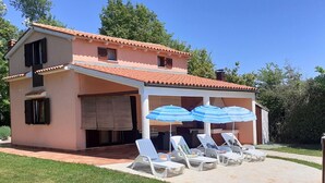 A two-story house with a covered patio area.