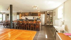 A spacious kitchen with a dining area, featuring a central island, modern appliances, and ample seating. - Ouffet Villa With Sauna, Liege (Ouffet)