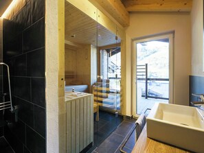 Enjoy a relaxing soak in the large bathtub or refreshing shower, with a view of the surrounding landscape.