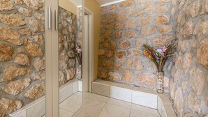 A hallway with stone walls and a tiled floor, leading to a door. - Captivating Holiday Home in Tribanj near Sea (Starigrad)