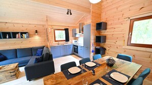 A cozy cabin with a dining area, kitchen, and living room.